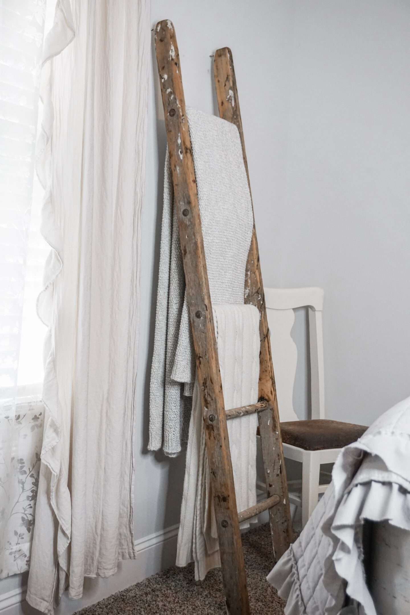 Farmhouse decorative blanket ladder anchored to the wall.